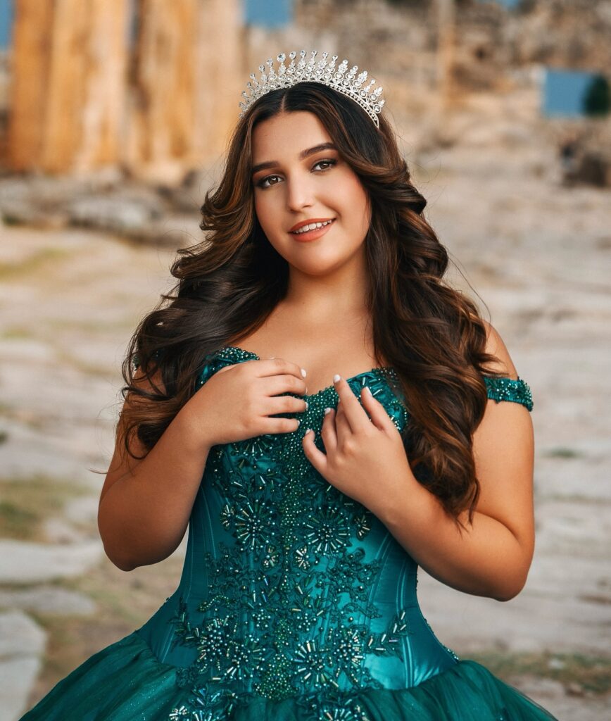 Emerald green off-shoulder quinceañera dress with silver tiara for rent in Orlando, FL
